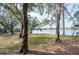 Spacious backyard with mature trees and scenic lake view at 7182 E Bank Dr # 7-103, Tampa, FL 33617