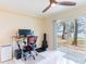 Bright home office features a stand-up desk, lake view, and built-in shelving at 7182 E Bank Dr # 7-103, Tampa, FL 33617