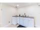 Small kitchen with white cabinets and a sink at 7182 E Bank Dr # 7-103, Tampa, FL 33617