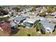 Aerial view of a home with a screened-in pool and a well-maintained backyard in a suburban neighborhood at 7644 Arlight Dr, New Port Richey, FL 34655