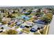 Aerial view capturing homes around a pond with lily pads in a well-established neighborhood at 7644 Arlight Dr, New Port Richey, FL 34655