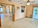 Spacious room featuring tile flooring, a ceiling fan, and a view to the kitchen at 7644 Arlight Dr, New Port Richey, FL 34655