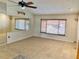 Spacious living area with tile flooring, ceiling fan, and large window for natural light at 7644 Arlight Dr, New Port Richey, FL 34655