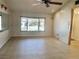 Bright, open living room featuring tile floors, a ceiling fan, and great natural light at 7644 Arlight Dr, New Port Richey, FL 34655