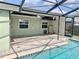 Inviting screened-in pool area with brick pavers, ceiling fans, and plenty of room for outdoor lounging and entertaining at 7644 Arlight Dr, New Port Richey, FL 34655