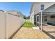 Exterior backyard view showing a white privacy fence and a screened-in patio at 11143 Rising Mist Blvd, Riverview, FL 33578