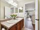 Bathroom with double sink vanity, decorative flowers and an open doorway into another room at 11143 Rising Mist Blvd, Riverview, FL 33578