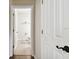 A white trimmed entry to a white bathroom with beige tiled floor at 11143 Rising Mist Blvd, Riverview, FL 33578