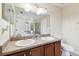 Bathroom featuring a double sink vanity with a large mirror and overhead lighting at 11143 Rising Mist Blvd, Riverview, FL 33578