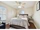 Cozy bedroom features a queen bed, ceiling fan, and natural light from the windows at 11143 Rising Mist Blvd, Riverview, FL 33578