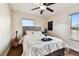 Bedroom with neutral decor features a queen-size bed, guitar, and window with blinds at 11143 Rising Mist Blvd, Riverview, FL 33578