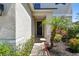 Home entryway with black door, and landscaped garden at 11143 Rising Mist Blvd, Riverview, FL 33578