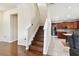 View of the kitchen and staircase, highlighting the open layout and transition between floors at 11143 Rising Mist Blvd, Riverview, FL 33578