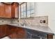 Kitchen sink view featuring stainless steel double sinks, granite countertops, and mosaic tile backsplash at 11143 Rising Mist Blvd, Riverview, FL 33578