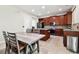 Kitchen featuring an island, stainless steel appliances, and adjacent dining area with tile floors at 11143 Rising Mist Blvd, Riverview, FL 33578