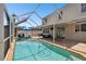 Screened-in pool area with covered patio, outdoor seating, and a view of the house at 11143 Rising Mist Blvd, Riverview, FL 33578