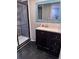 Bathroom featuring black floors, a vanity with a sink, and a glass shower at 12707 Blue Pine Cir, Hudson, FL 34669