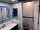 Bathroom with framed mirror, vanity with modern hardware, toilet in separate room at 12707 Blue Pine Cir, Hudson, FL 34669