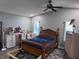 Bedroom featuring wood look floors, neutral paint, ceiling fan and natural light coming through the windows at 12707 Blue Pine Cir, Hudson, FL 34669