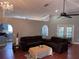 Open living room featuring ceiling fan, arched doorways, and tile floors at 12707 Blue Pine Cir, Hudson, FL 34669