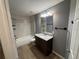 Bathroom featuring a shower and tub combo, granite vanity, and neutral tile flooring at 13193 Paxton Ave, Weeki Wachee, FL 34614