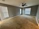 Spacious carpeted main bedroom with a ceiling fan, and natural lighting from dual windows at 13193 Paxton Ave, Weeki Wachee, FL 34614