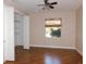 Bedroom with hardwood floors, window with shade, and a closet at 24289 Toth Ln, Punta Gorda, FL 33955