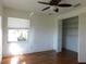 Bedroom with hardwood floors, walk-in closet, and large window at 24289 Toth Ln, Punta Gorda, FL 33955