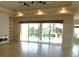 Bright living room featuring tiled floors, a fireplace, and a view of the pool through sliding glass doors at 24289 Toth Ln, Punta Gorda, FL 33955