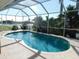 Enclosed pool with screened in area and view of the lake and tropical foliage at 24289 Toth Ln, Punta Gorda, FL 33955