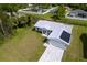 New construction home with a gray roof and a paved driveway at 8126 Chesebro Ave, North Port, FL 34287
