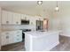 Modern kitchen boasting white cabinets, quartz countertops, and stainless steel appliances at 8126 Chesebro Ave, North Port, FL 34287