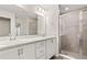 Main bath featuring dual sinks, a large mirror, and a walk-in shower at 2614 58Th E Cir, Palmetto, FL 34221