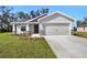 New single-Gathering home featuring a two-car garage, landscaped yard, and gray paint at 2614 58Th E Cir, Palmetto, FL 34221