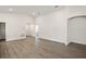 Open-concept living room featuring an arched doorway and wood-look flooring at 2614 58Th E Cir, Palmetto, FL 34221