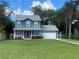 Two-story house with a gray exterior, red door and a two-car garage at 6704 N 13Th St, Tampa, FL 33604