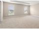 Large main bedroom featuring carpet flooring, two sunny windows, and a ceiling fan at 2618 58Th E Cir, Palmetto, FL 34221