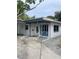 White single story house with covered entryway and a carport at 3967 Arkansas Ne Ave, St Petersburg, FL 33703