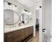 Updated bathroom with a double vanity and stylish mirrors at 1413 Sandalwood Dr, Plant City, FL 33563