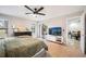 Main bedroom with a king-size bed, TV, and access to a back patio at 1413 Sandalwood Dr, Plant City, FL 33563