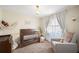 Peaceful Bedroom, featuring a crib and a comfy armchair at 1413 Sandalwood Dr, Plant City, FL 33563