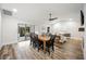 Light-filled dining area with wood table and chairs, hardwood floors and access to a back patio at 1413 Sandalwood Dr, Plant City, FL 33563