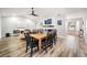 Bright dining room features a wood table with black chairs, hardwood floors and a view into the living room at 1413 Sandalwood Dr, Plant City, FL 33563