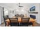 Dining area with wood table and black chairs, hardwood floors, and fireplace at 1413 Sandalwood Dr, Plant City, FL 33563