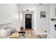 Bright and airy entryway with a modern black door and wood flooring at 1413 Sandalwood Dr, Plant City, FL 33563