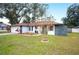 Single story home with updated landscaping and a two-car garage at 1413 Sandalwood Dr, Plant City, FL 33563