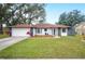 Beautiful house with a red tile roof, white exterior, and stone accents at 1413 Sandalwood Dr, Plant City, FL 33563