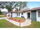 Newly renovated home with a stone facade and a well-maintained lawn at 1413 Sandalwood Dr, Plant City, FL 33563