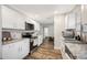 Modern kitchen with white cabinets, granite countertops, and stainless steel appliances at 1413 Sandalwood Dr, Plant City, FL 33563