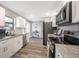 Modern kitchen with white cabinets, granite countertops, and stainless steel appliances at 1413 Sandalwood Dr, Plant City, FL 33563
